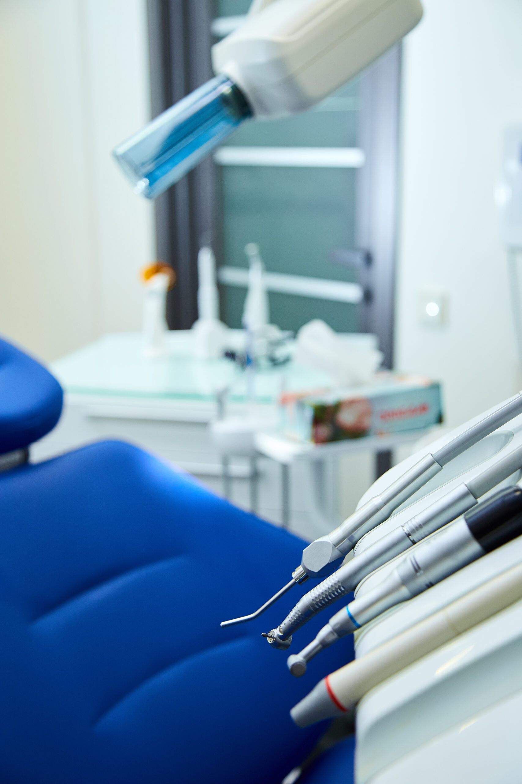 Modern metallic dentist tools and burnishers on a dentist chair